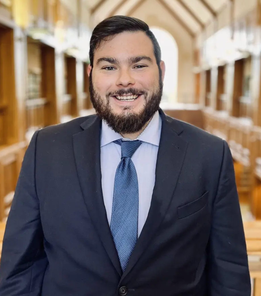 A man with a beard wearing a suit and tie