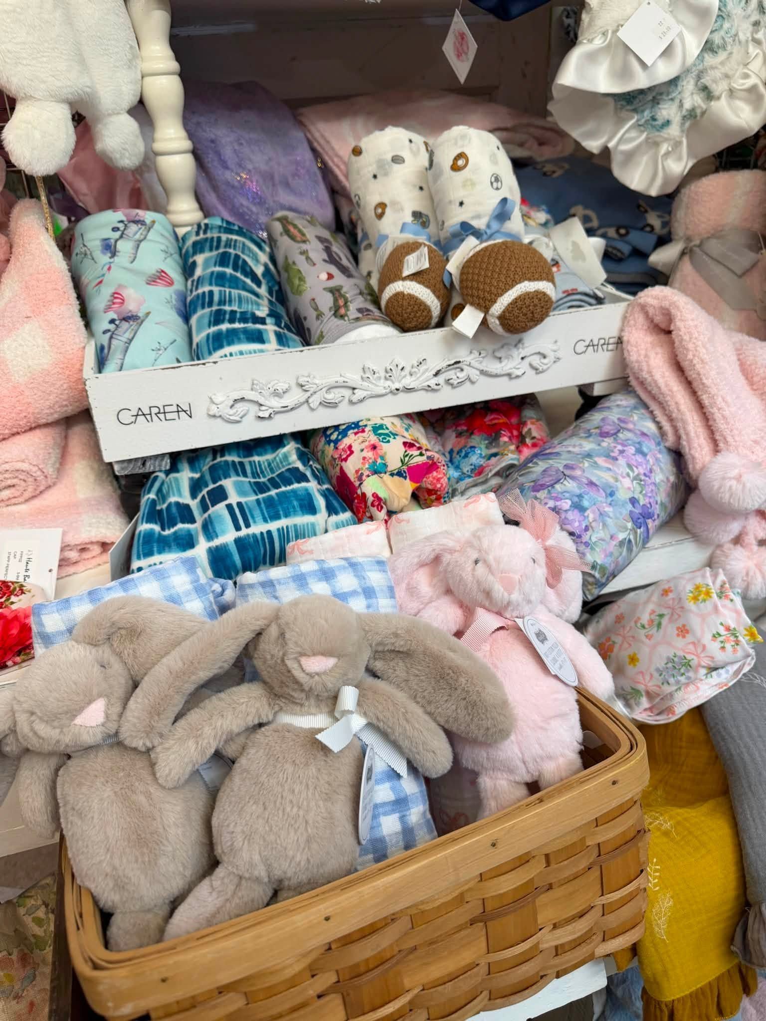 Basket of handmade stuffed bunnies and plush toys in pastel fabrics and patterns