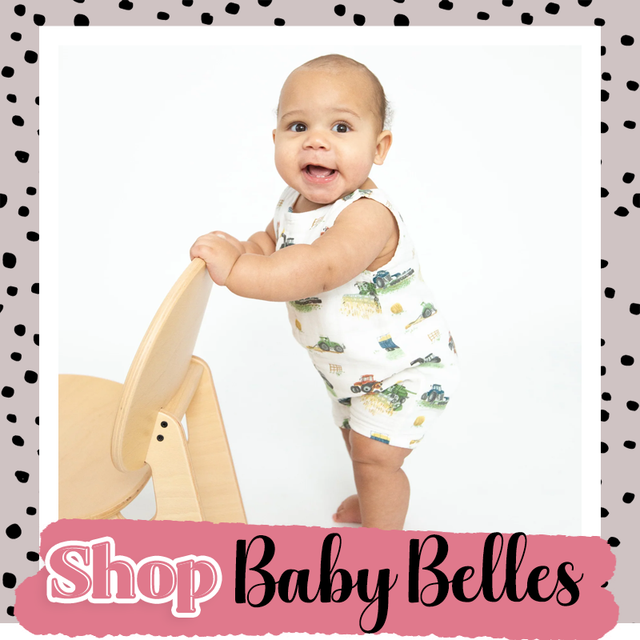 Baby standing and holding a wooden chair, with “Shop Baby Belles” text on a pink banner.