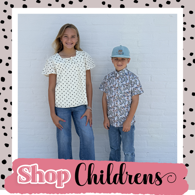 Two children modeling polka-dot shirts and jeans against a white wall, with “Shop Childrens” banner below.