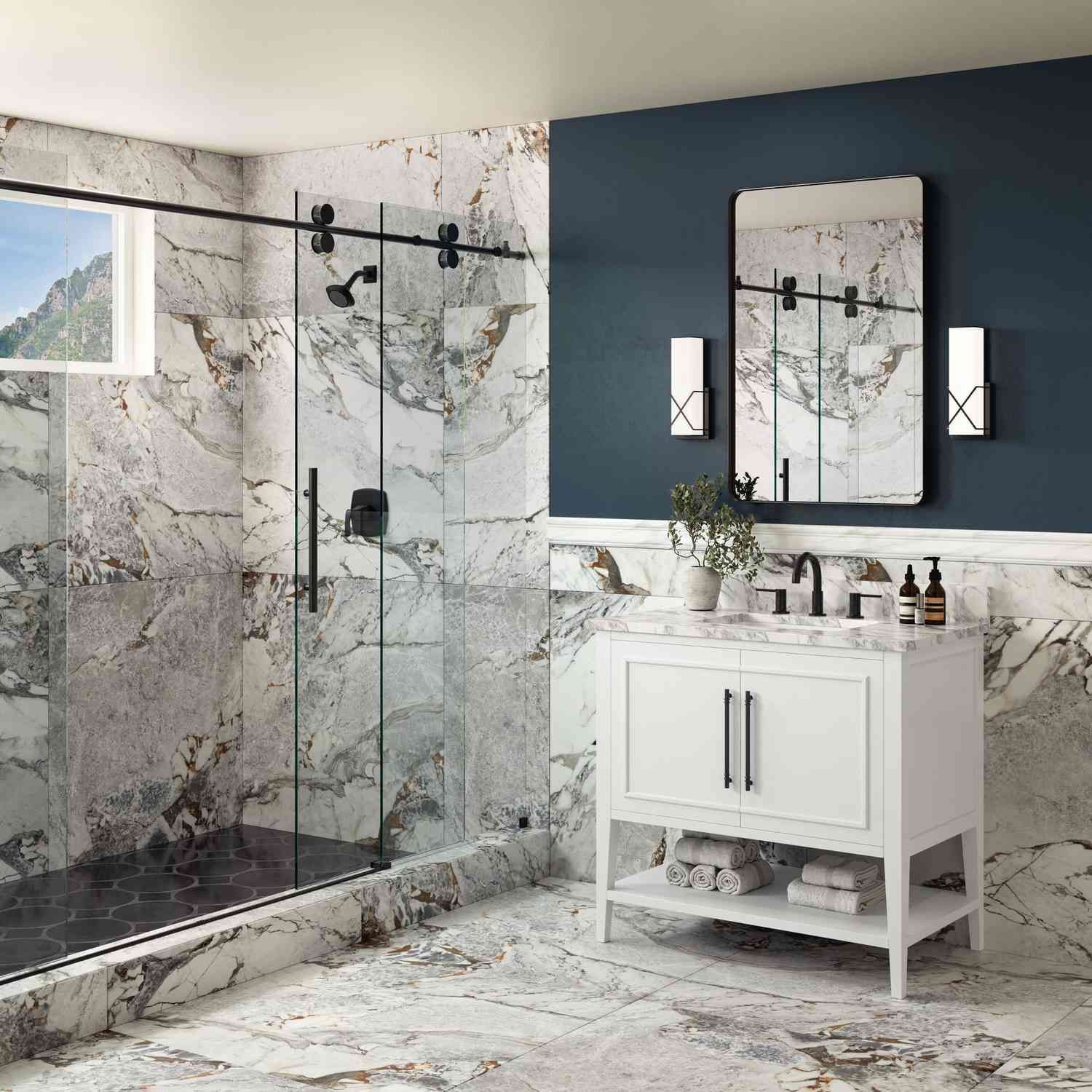 A bathroom with a sink , mirror and shower stall