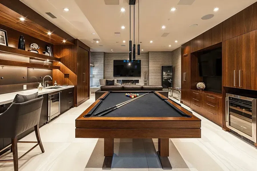 There is a pool table in the middle of the room.
