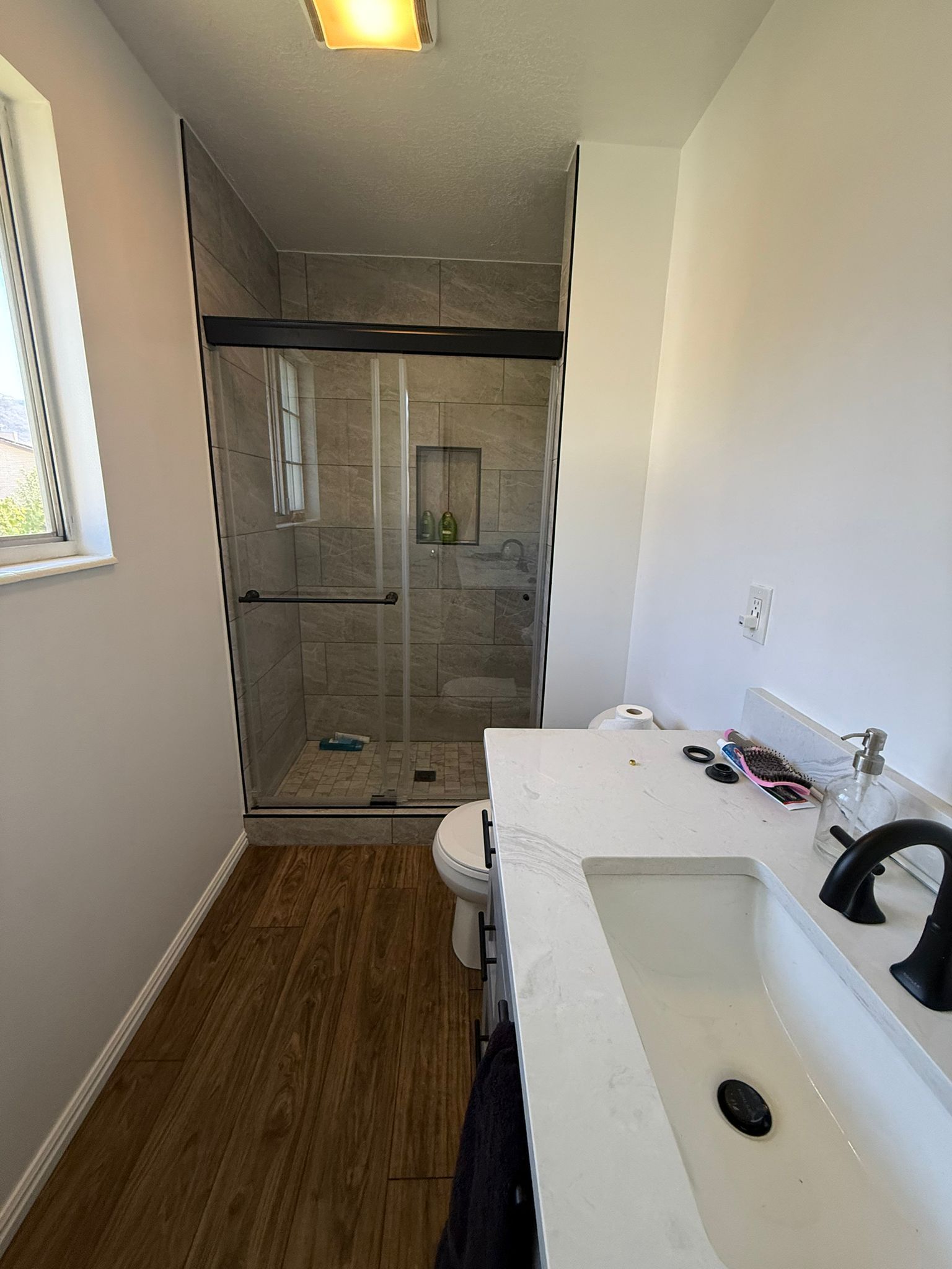 A bathroom with two sinks and a large mirror