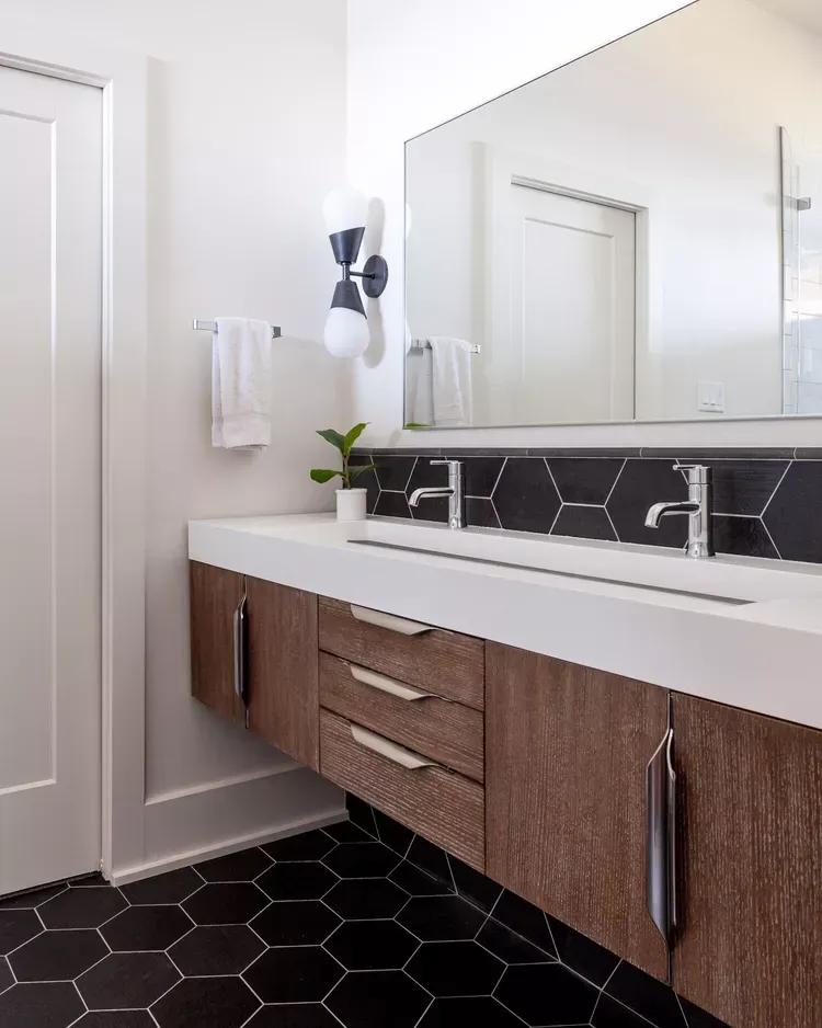 A kitchen with blue cabinets and white counter tops