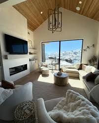 A living room with a fireplace , couch , chair and television.