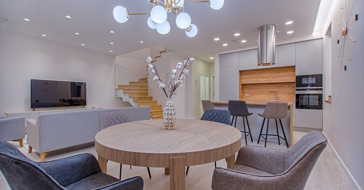 There is a table and chairs in the middle of the room.
