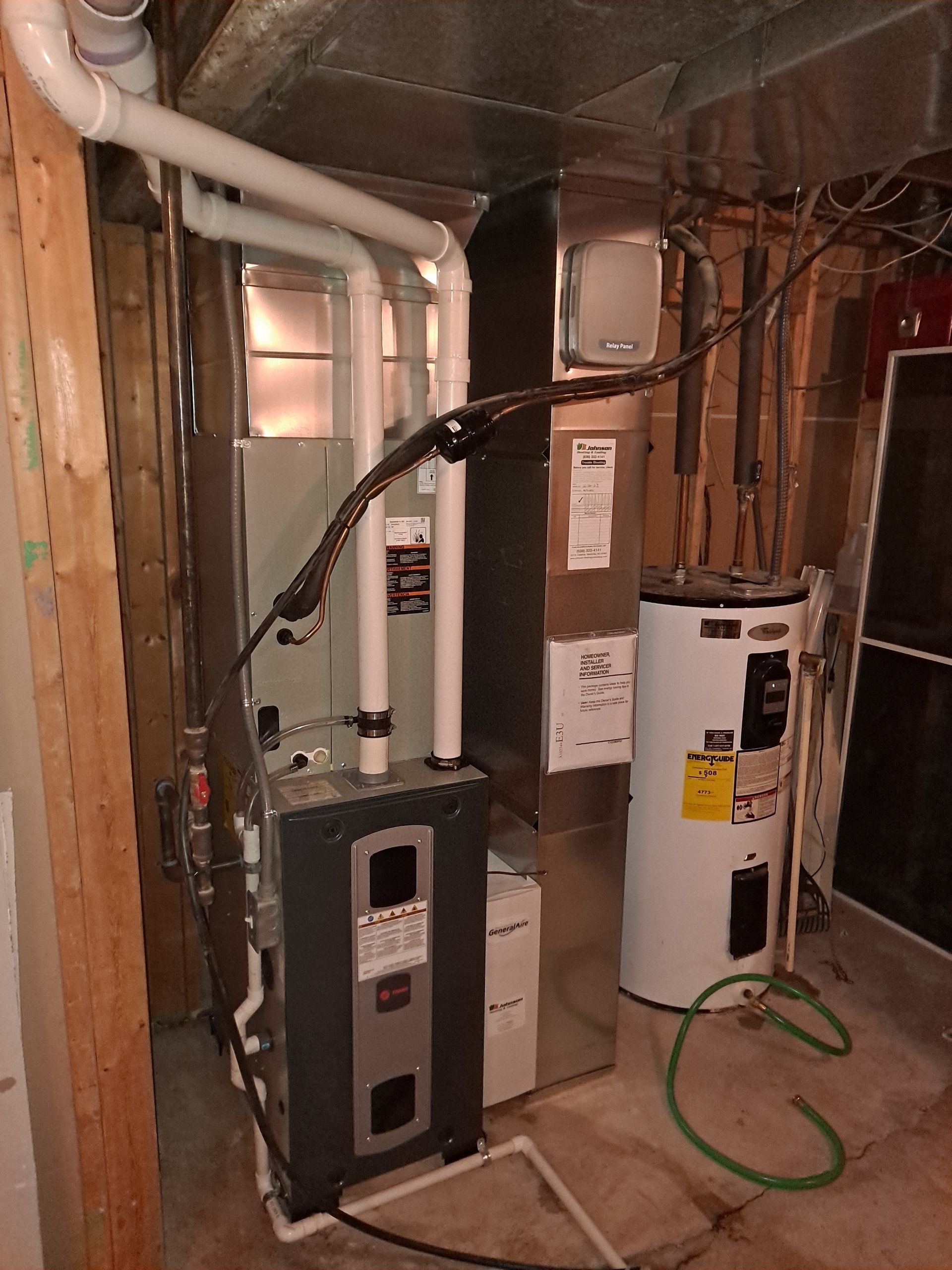 An air conditioner and a water heater in a basement