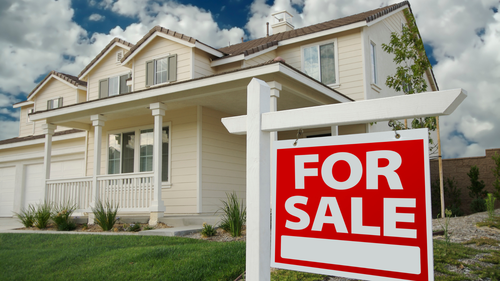 For sale sign in front of a suburban home listed on the real estate market