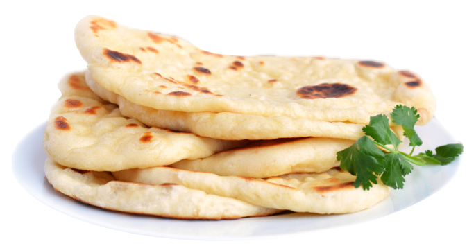 Stack of naan bread on a white plate, with brown spots and green herb garnish.