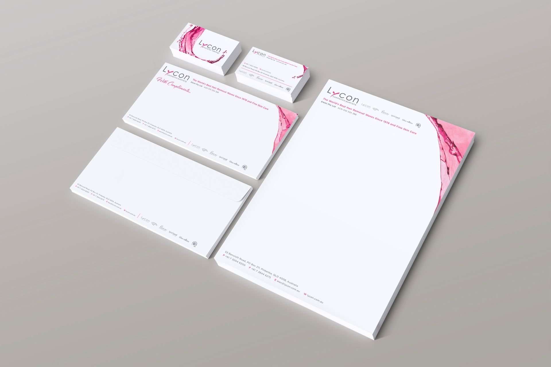 A set of business cards , envelopes , and a letterhead on a table.
