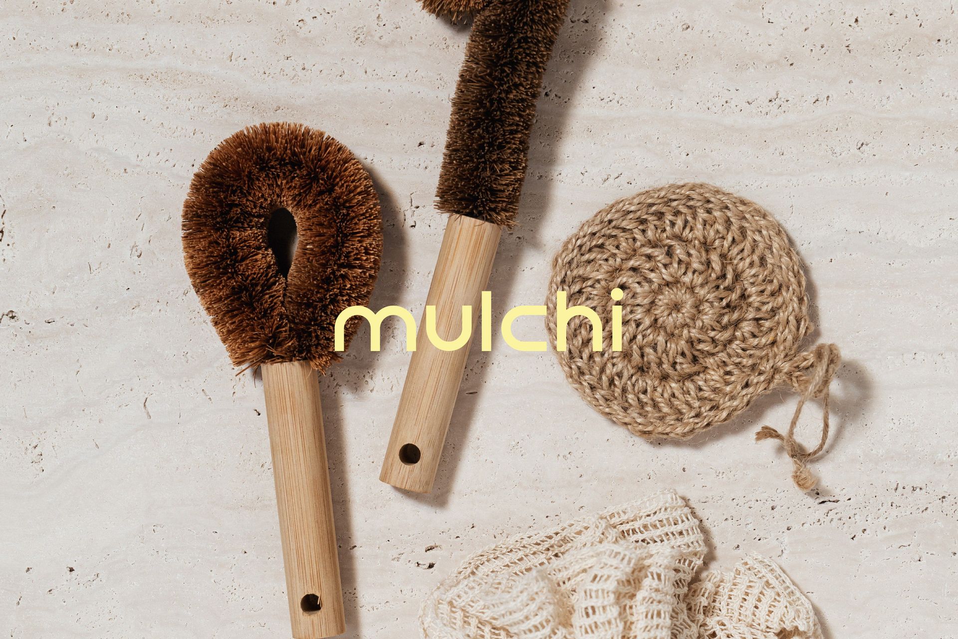 A bunch of brushes and sponges are sitting on a table.