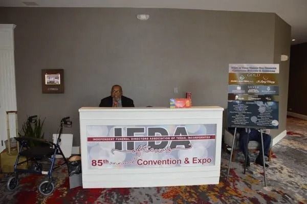 Registration desk for TEDA Convention & Expo, with staff behind a white counter in a hotel lobby.