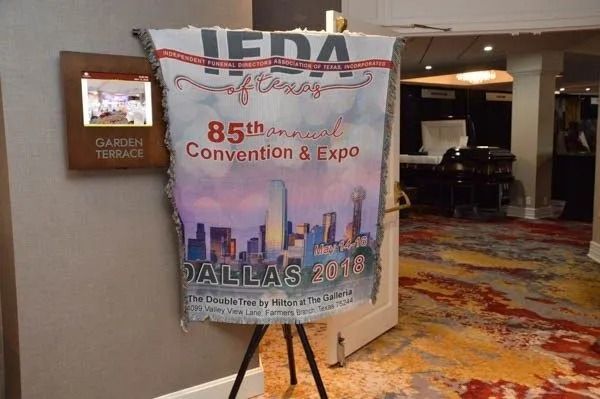 JDA Conference banner on an easel in a hotel lobby, reading “85th Convention & Expo” and “Dallas 2018”