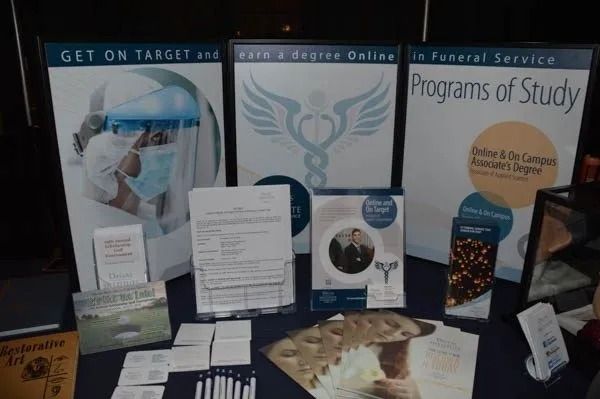 Health science display booth with posters, brochures, models, and informational handouts on a table