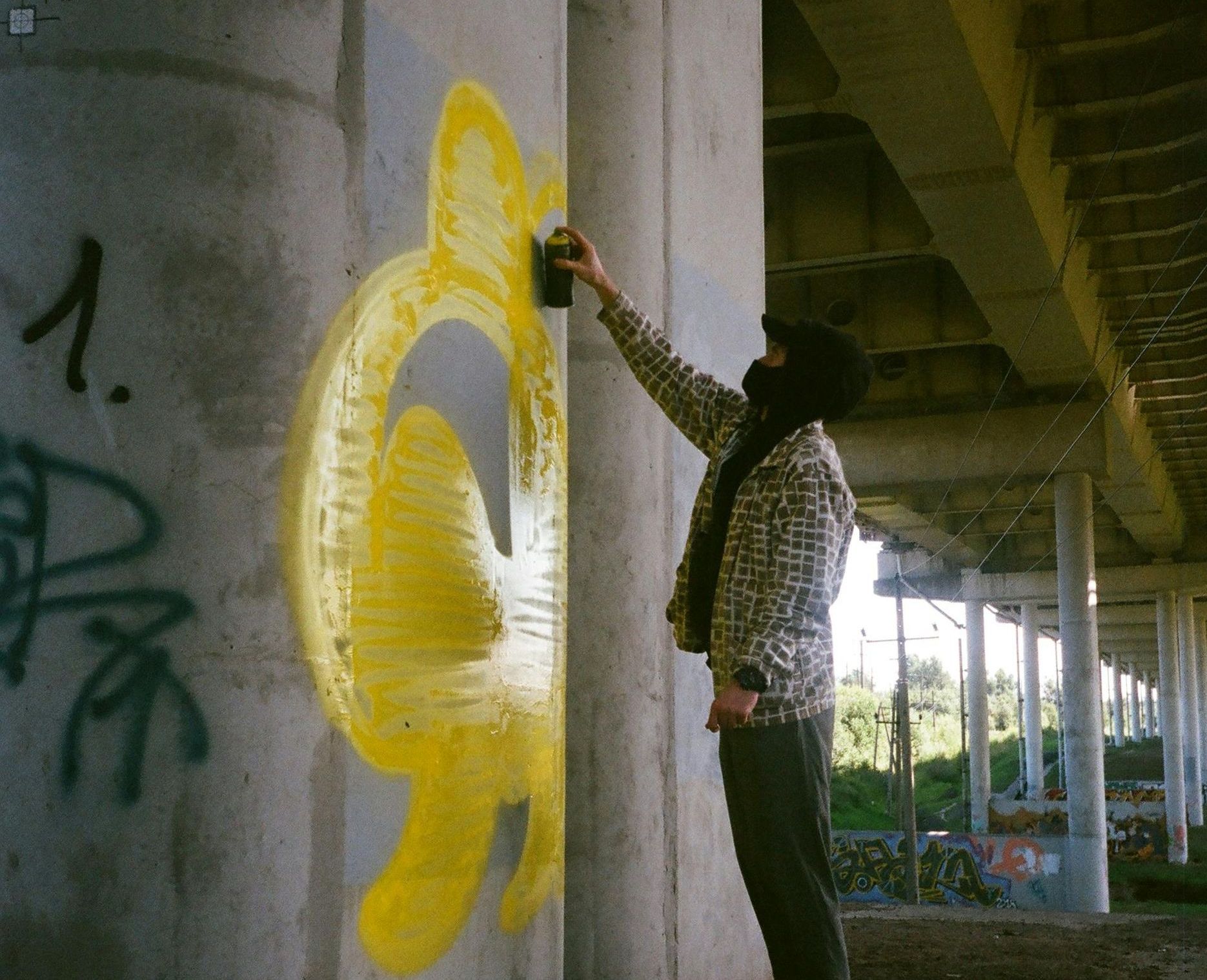 teenager vandalizing a wall at an apartment building