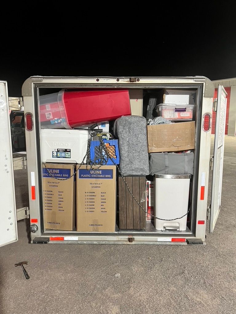 A trailer is filled with boxes and other items.