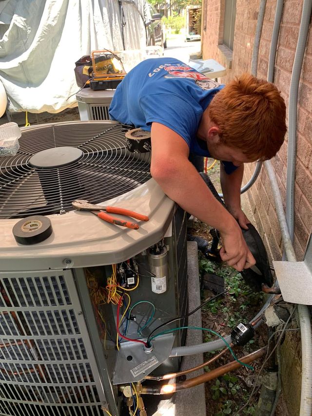 HVAC technician diagnosing an air conditioning system.