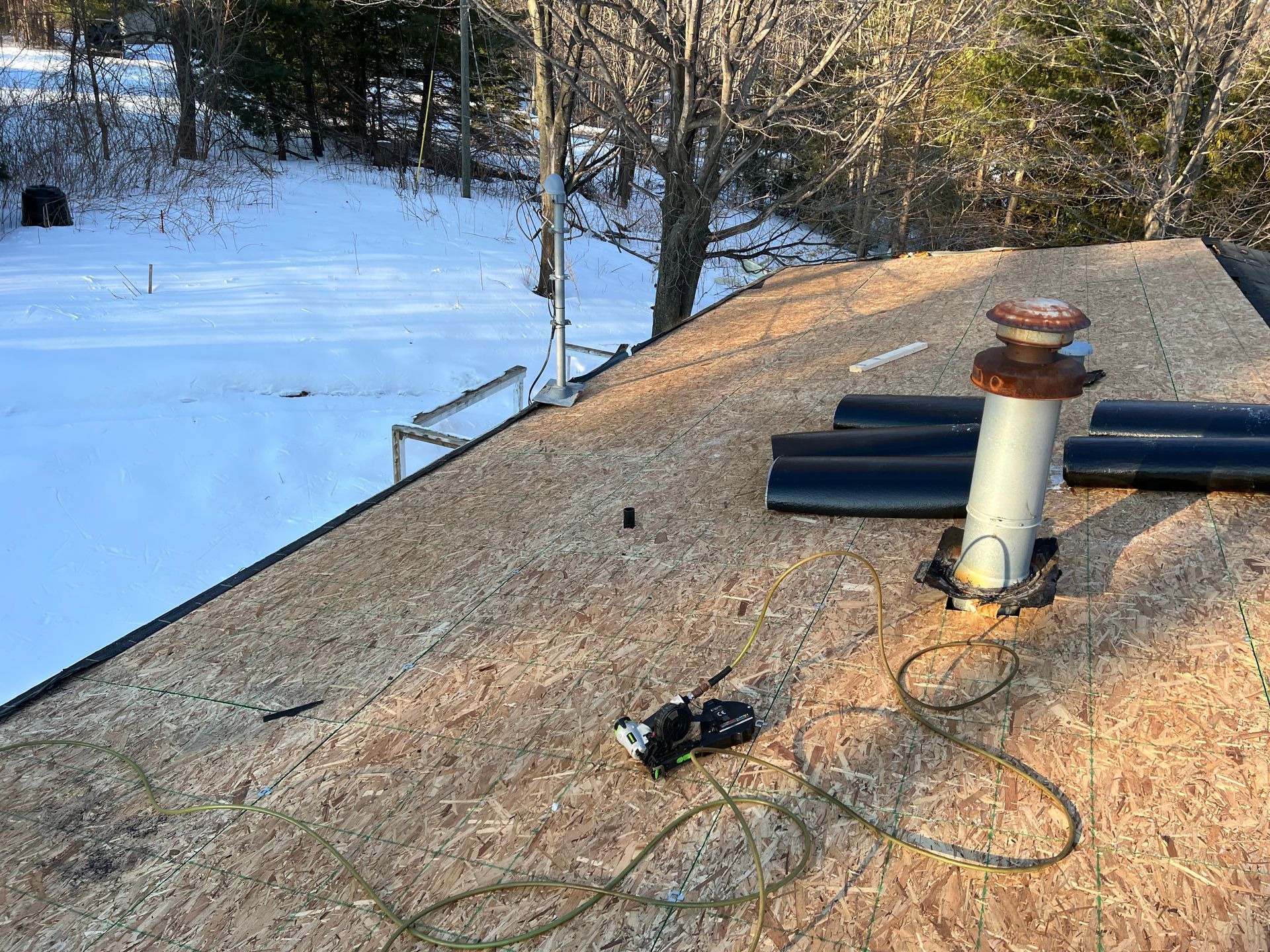 Residential roof with decking and membrane installation.
