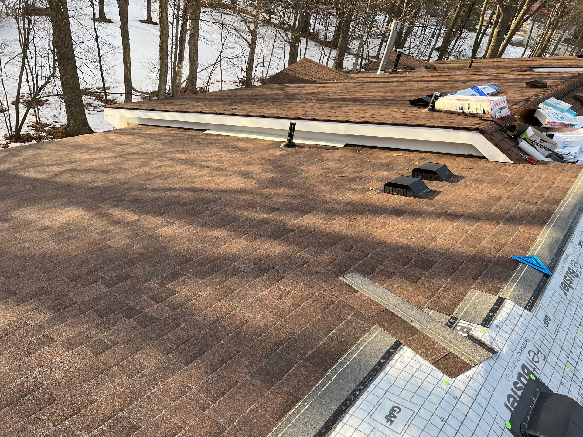Brown asphalt shingle replacement on top of a house in Gaylord, MI