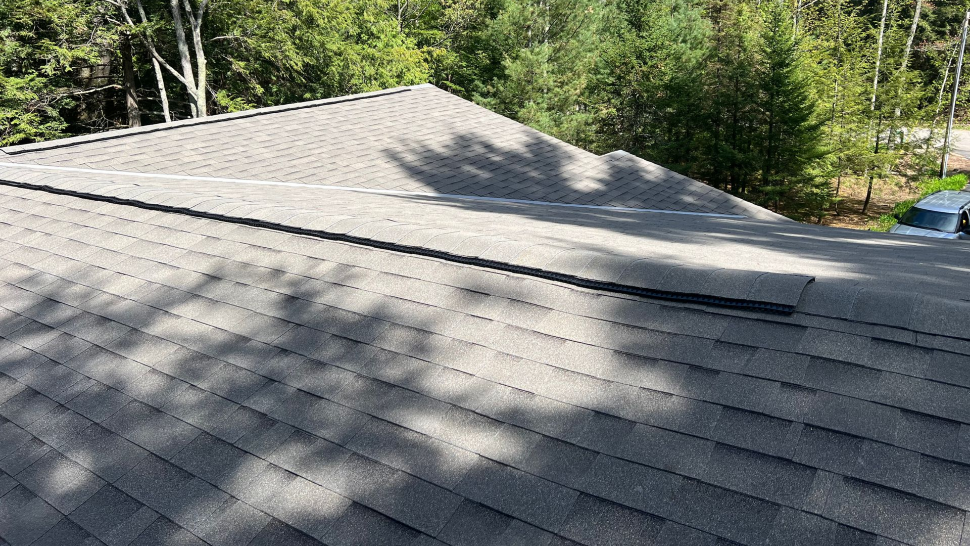 An elevated view of a gray asphalt shingle roof installation in Gaylord, MI.