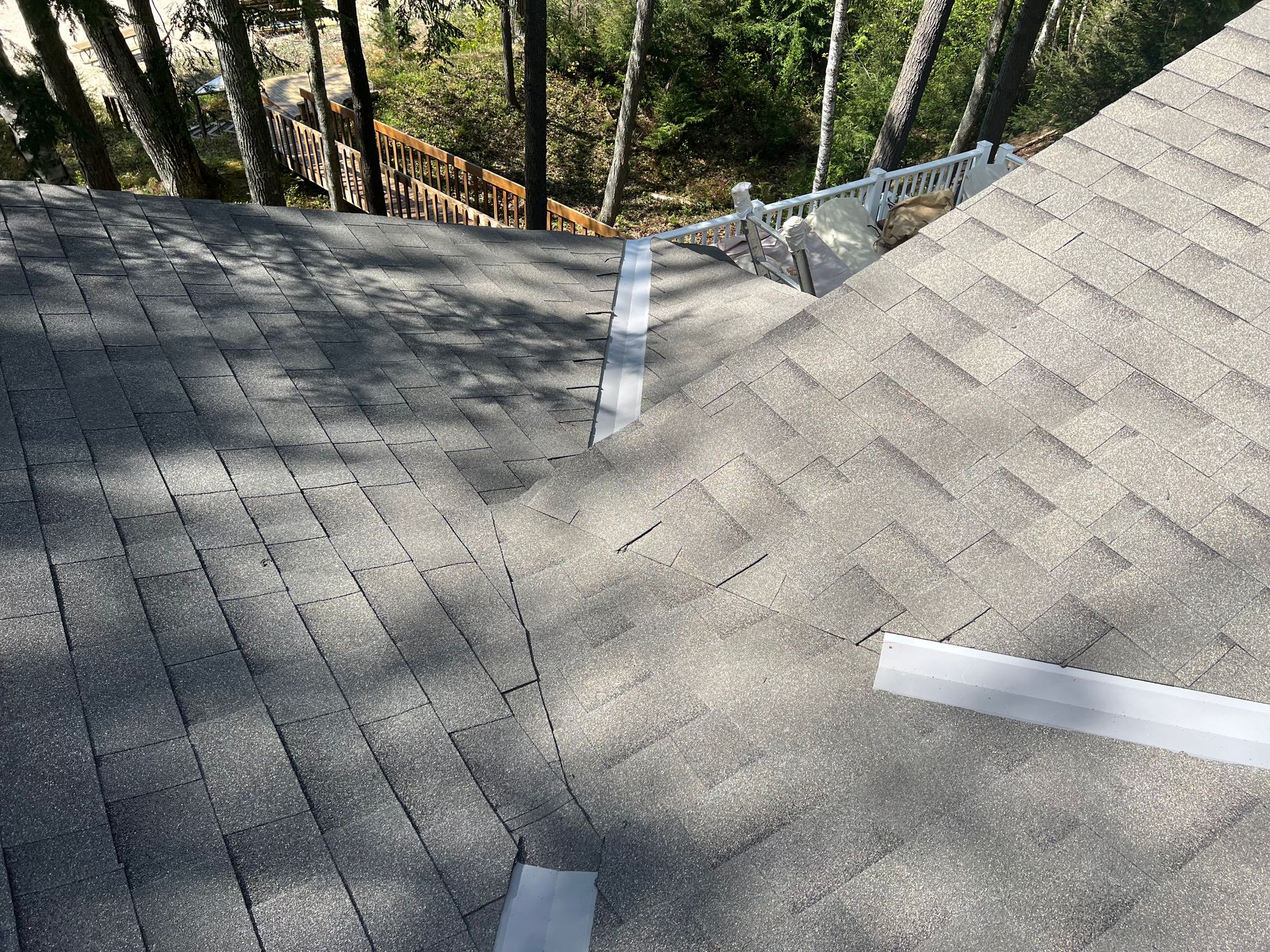 A high-angle view of a grey asphalt shingle roof installation in Gaylord, MI.