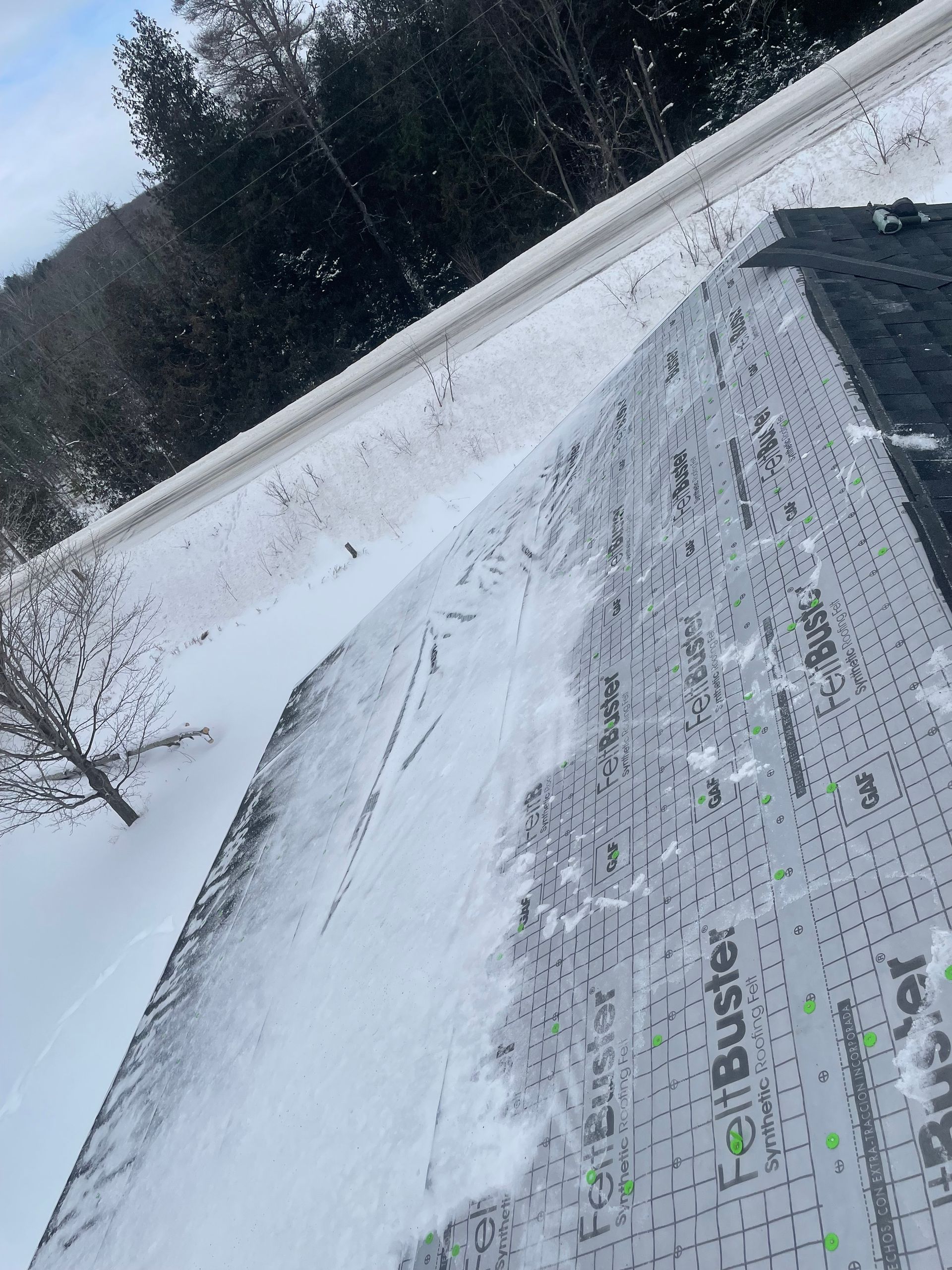 Residential shingle roof replacement progress in Gaylord, MI.