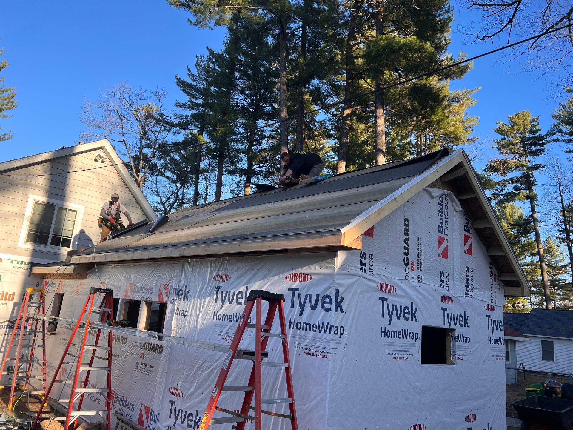 Alpine Brothers Construction team working on a residential roof and siding replacement