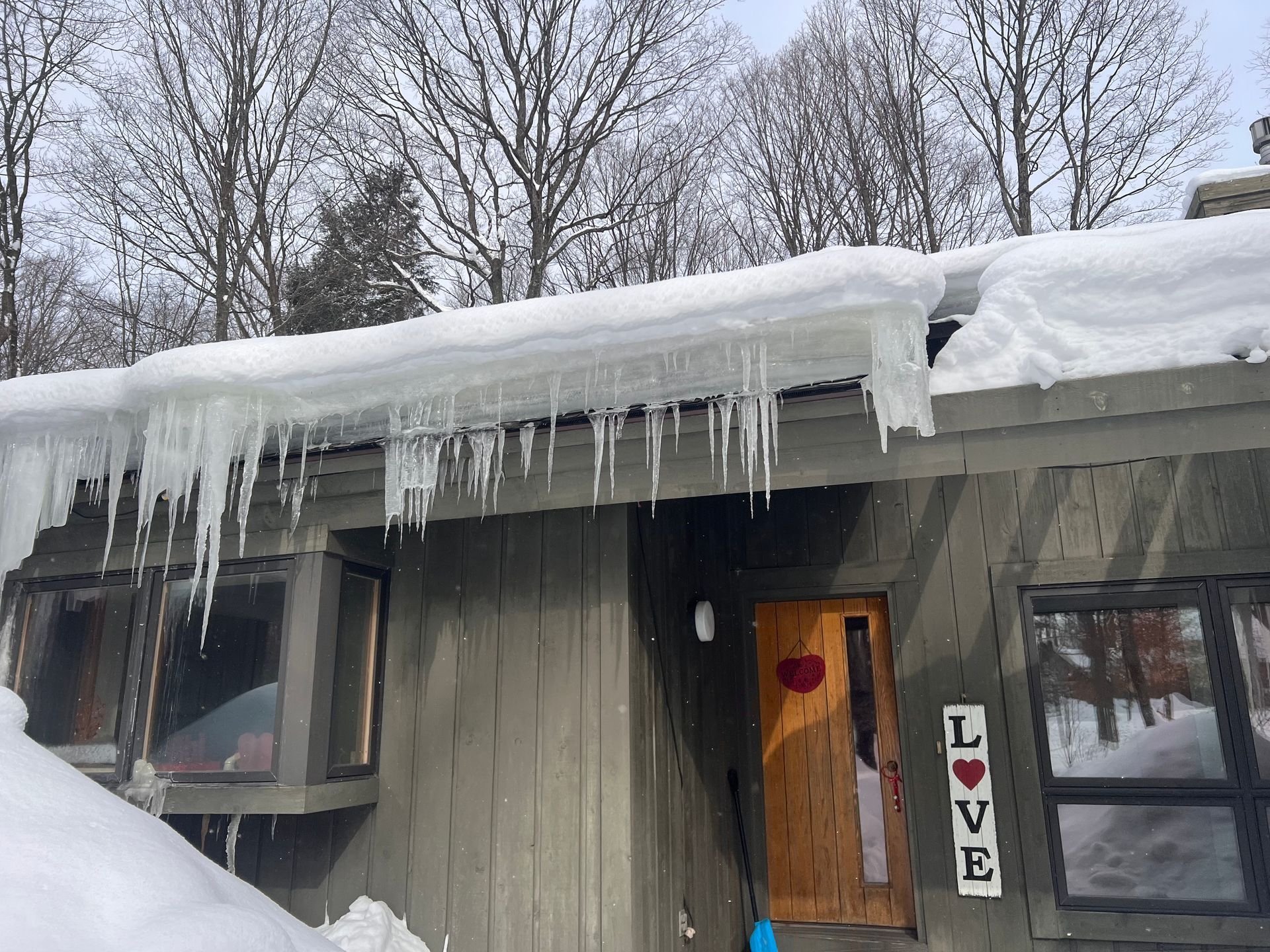 Residential roof before ice dam removal in Gaylord, MI.