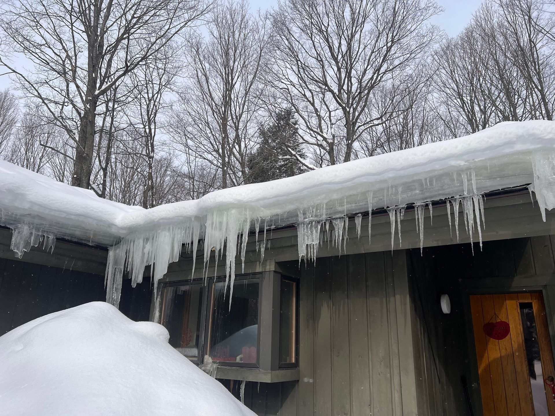 Closeup image of an ice damn on a residential roof in Gaylord, MI.