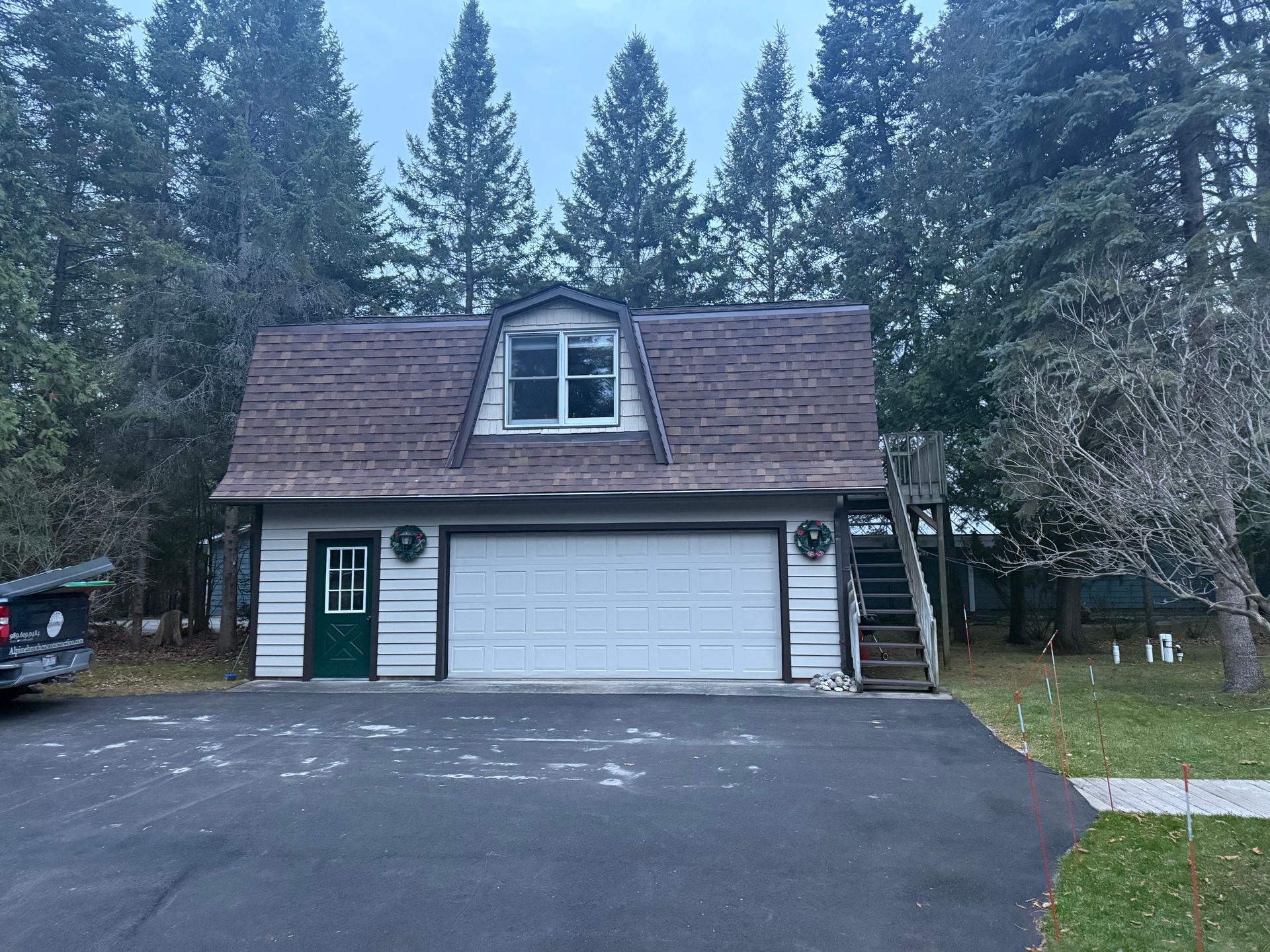 Residential shed with a new asphalt roof installation