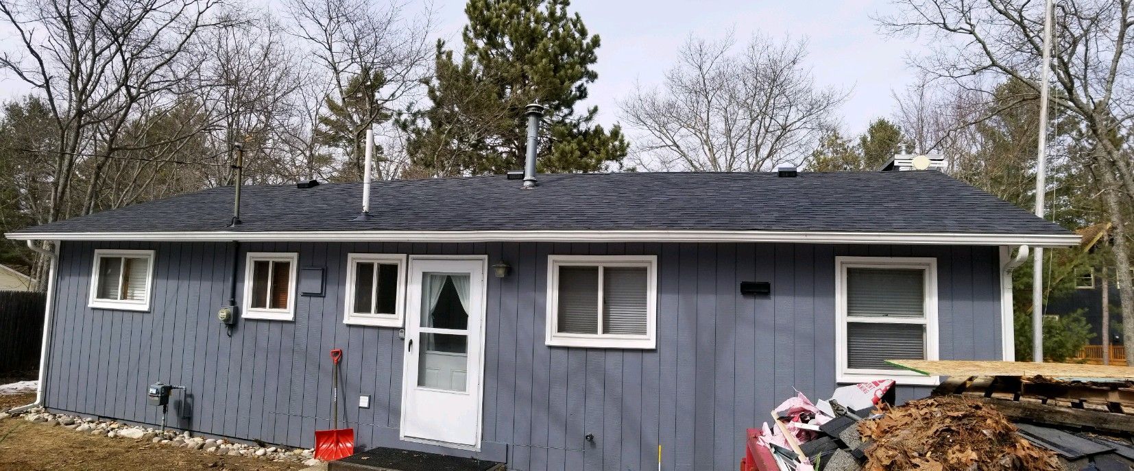 House with new window installation, new siding installation, and new asphalt roofing installation