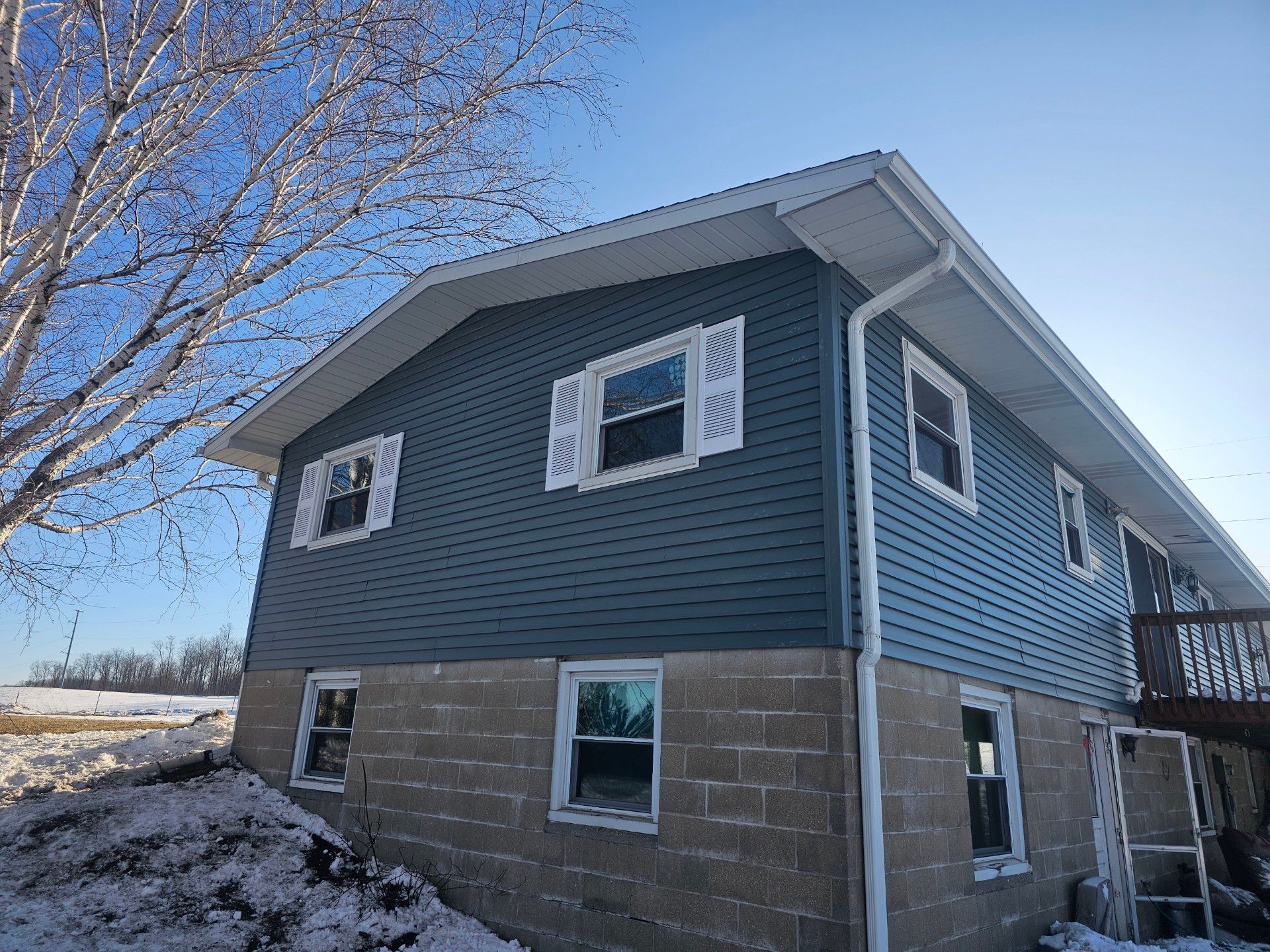 Two-story home with a cement basement and new siding installation by Alpine Brothers Construction