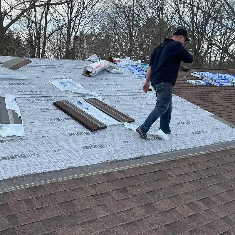 Alpine Brothers Construction team member walking on roof of residential roof replacement project