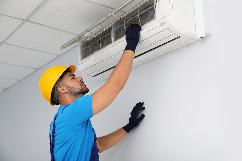 man checking the air conditioner