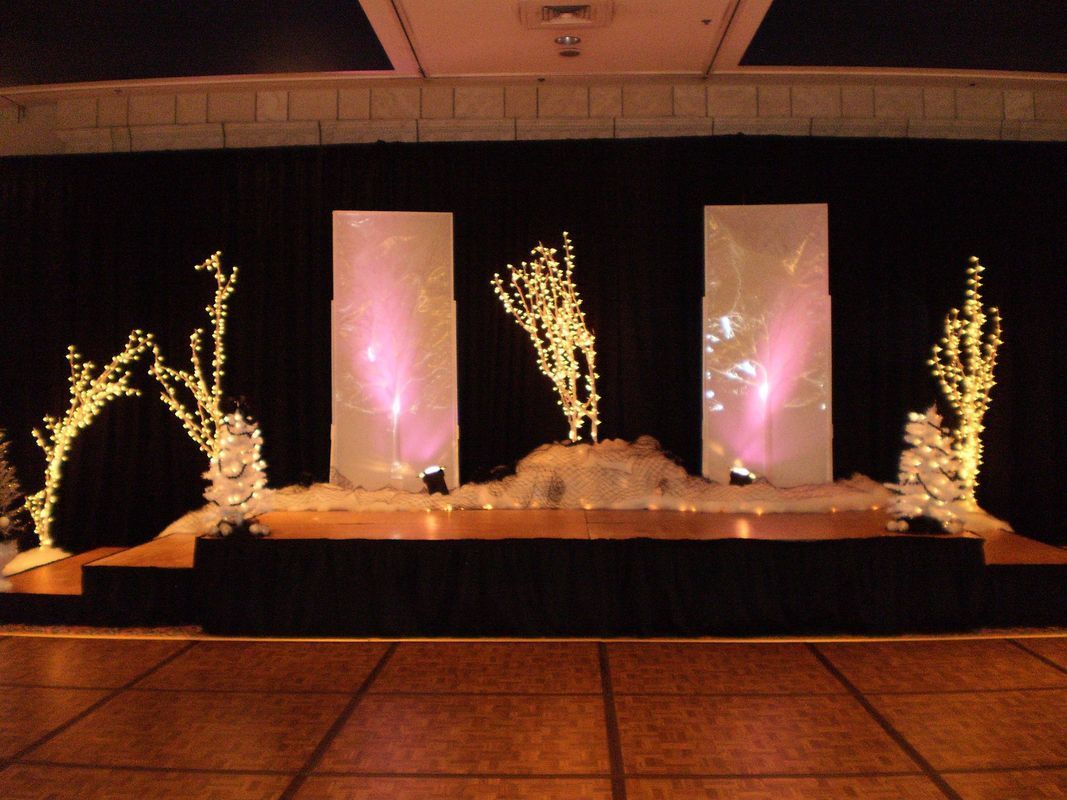 A stage with trees and lights on it