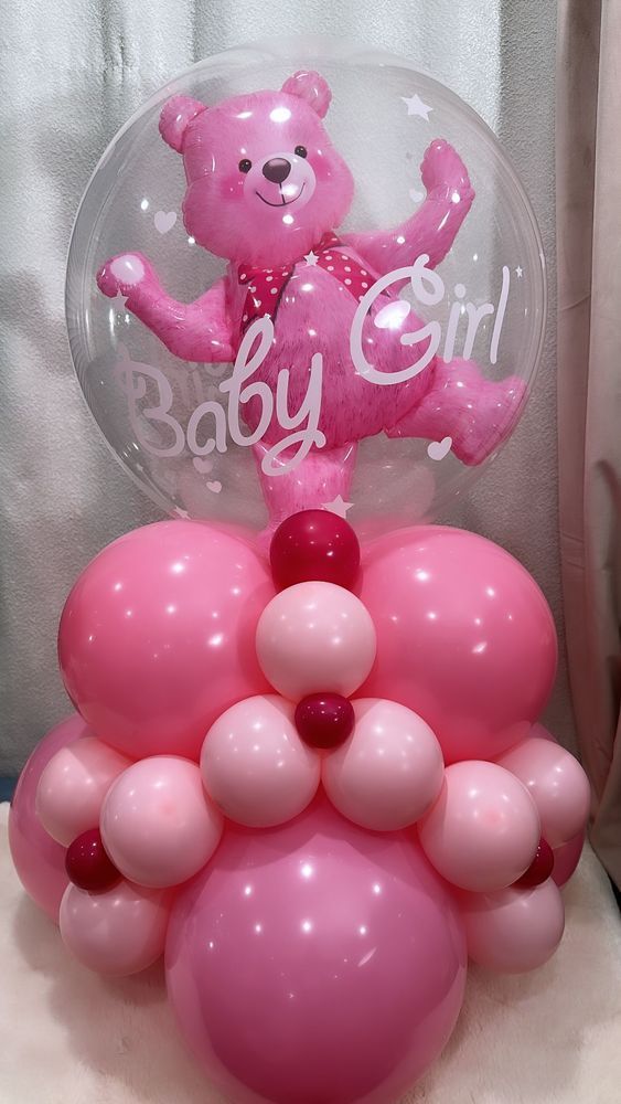 Pink balloon arrangement with a baby girl Winnie the Pooh.