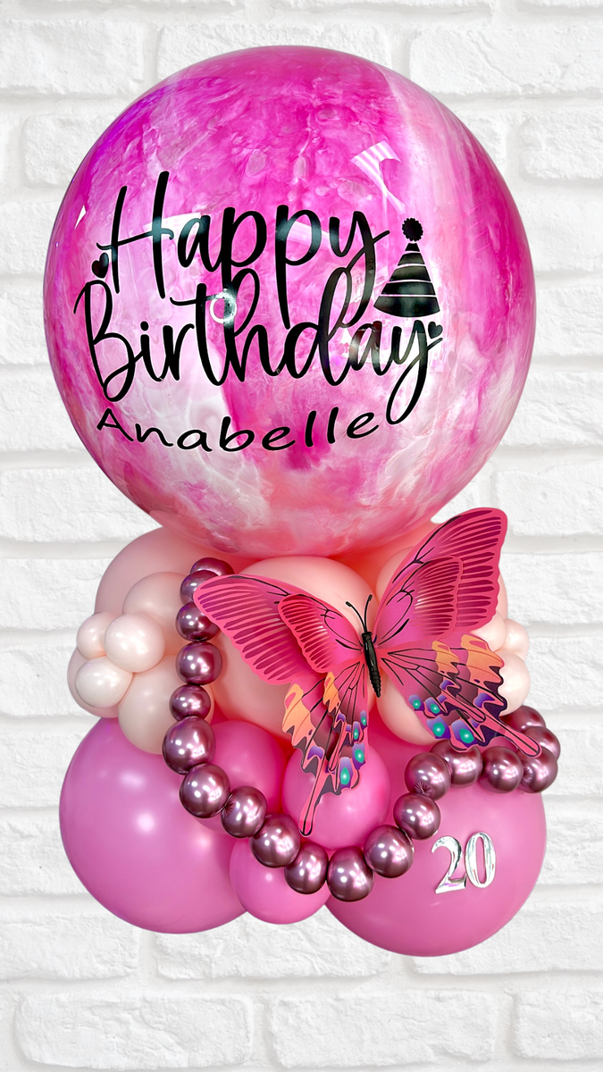 Pink birthday balloon arrangement with a butterfly and the name