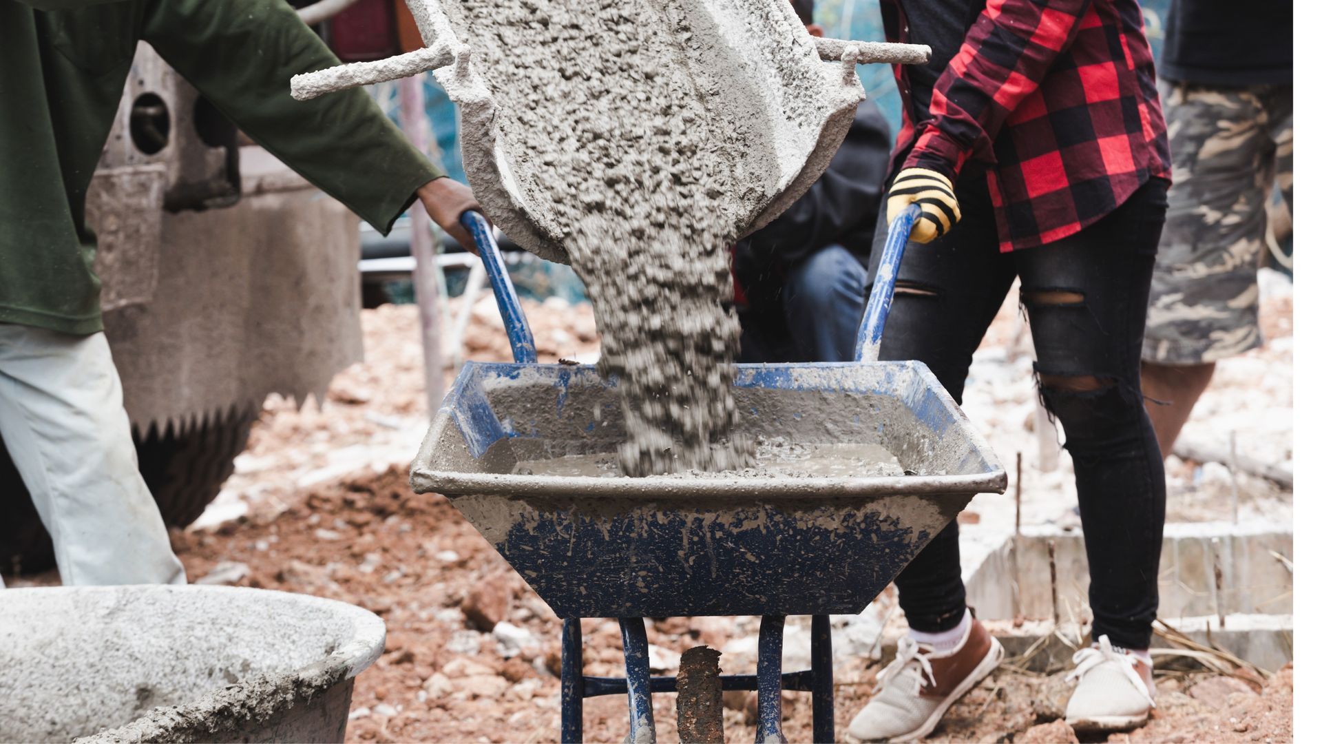 Concrete being poured into a wheelbarrow from a Volumetric Concrete Wagon from PureMix, Rochdale