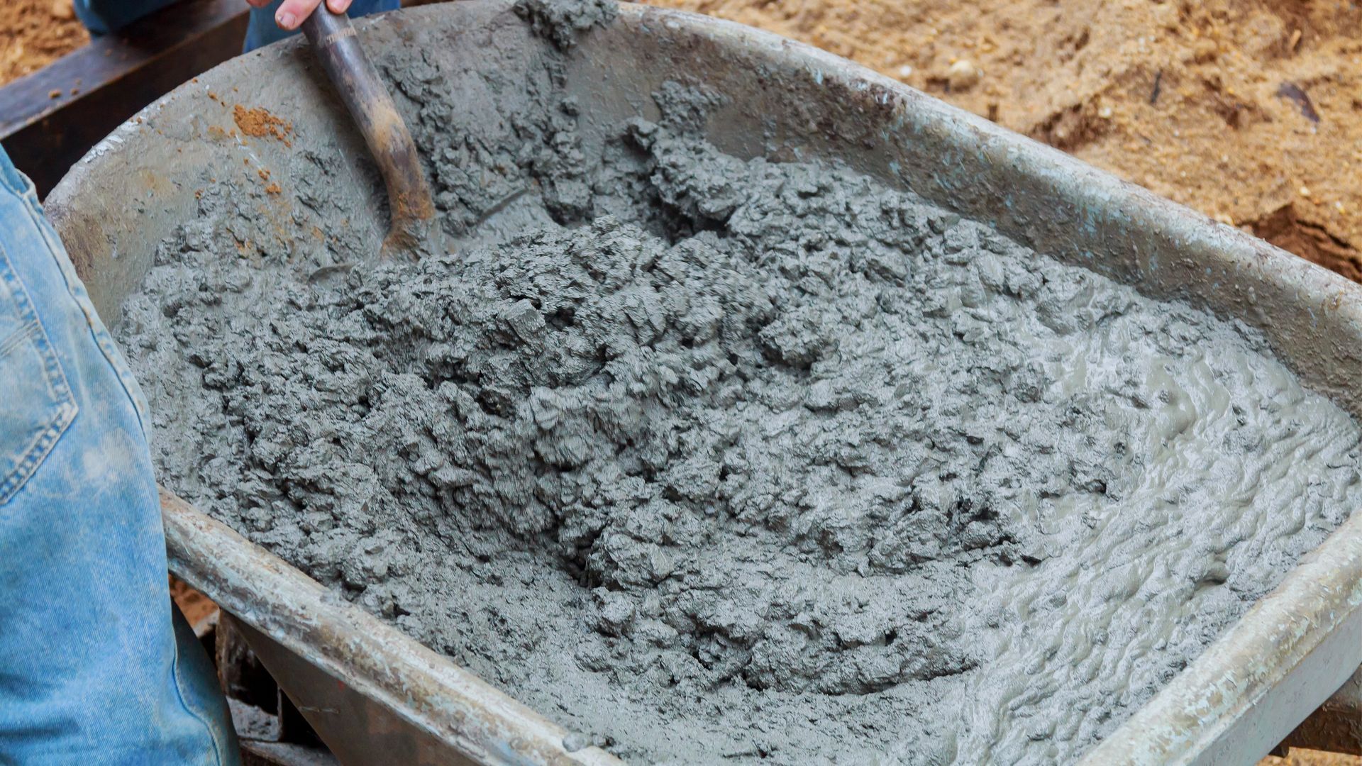 Concrete in a wheelbarrow with a shovel in it. Concrete supplied from PureMix, Concrete, Rochdale.