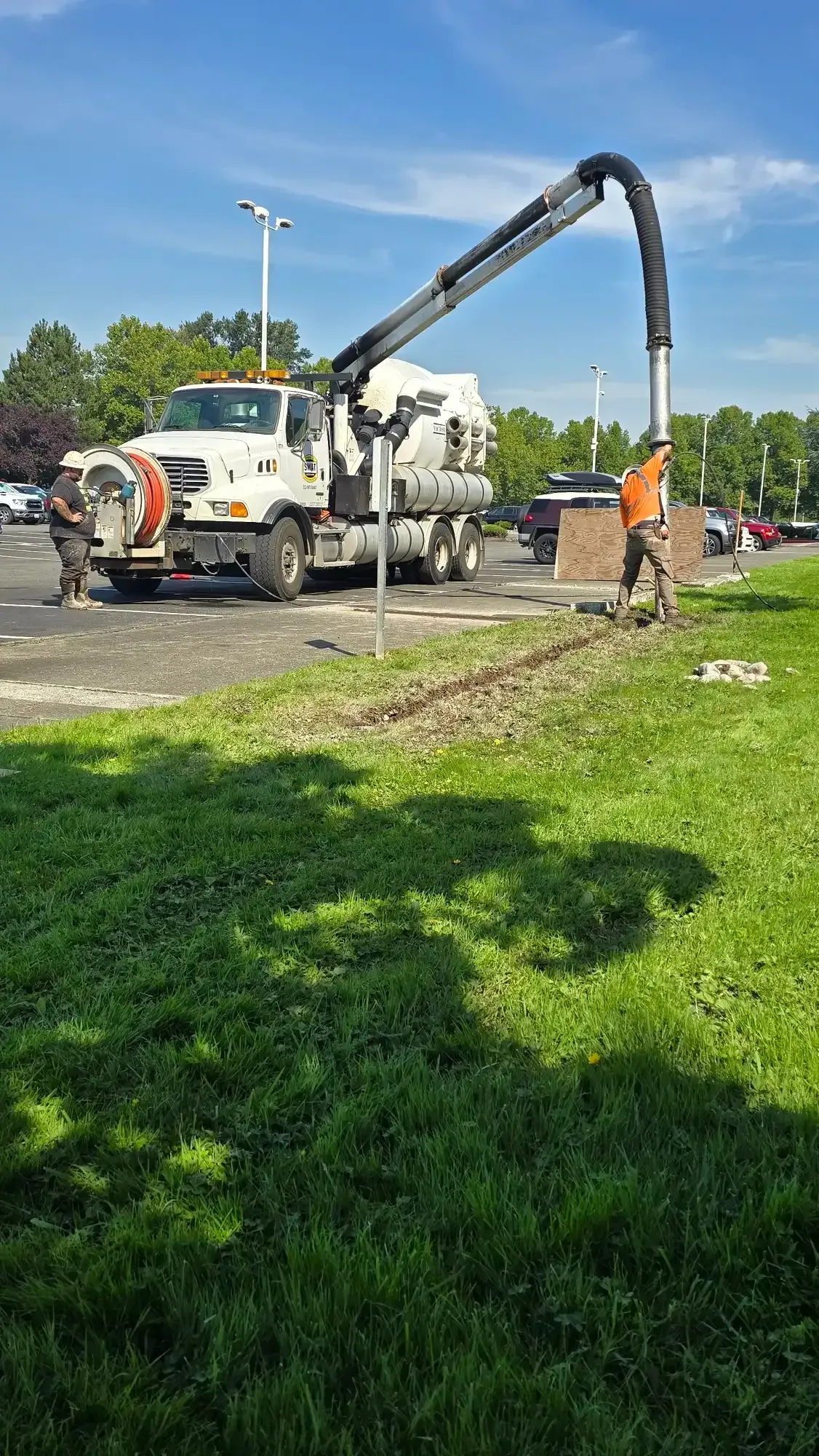 SWAT crew setting cones and staging the hydro excavation truck before digging at a commercial site