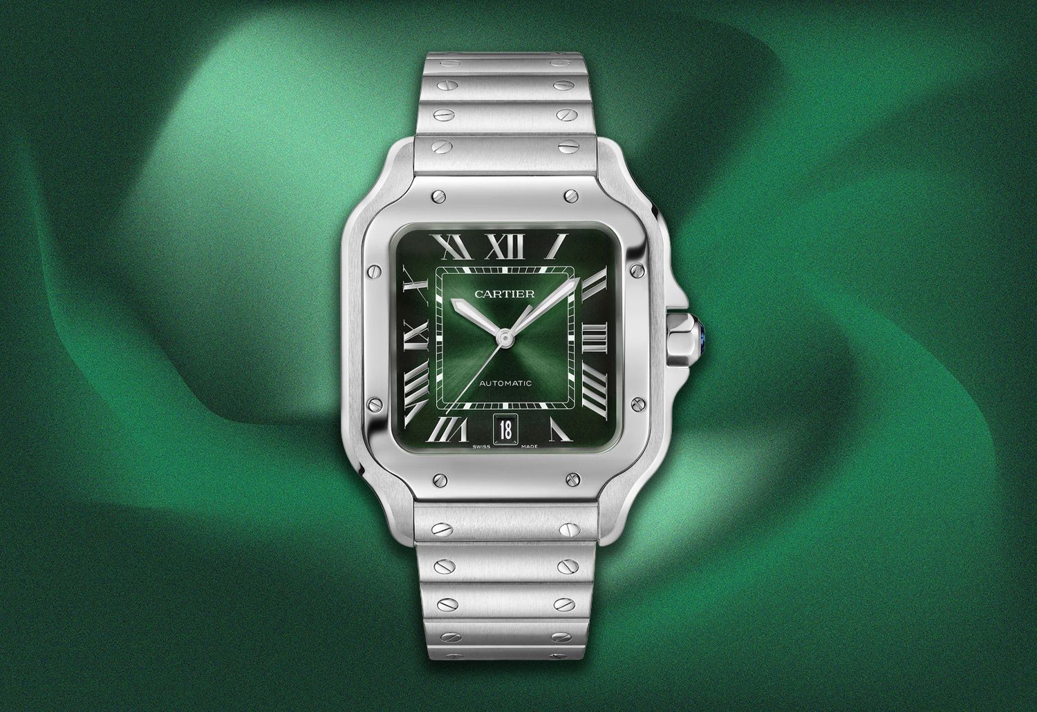 Cartier Santos de Cartier watch with a green dial, silver case and bracelet, on a green background.
