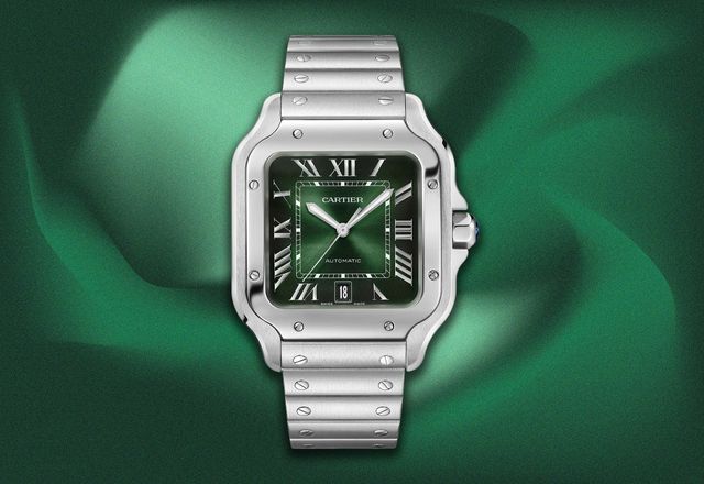 Cartier Santos de Cartier watch with a green dial, silver case and bracelet, on a green background.