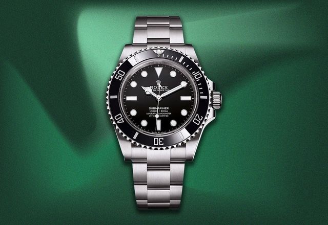 Rolex Submariner watch on a green textured background.