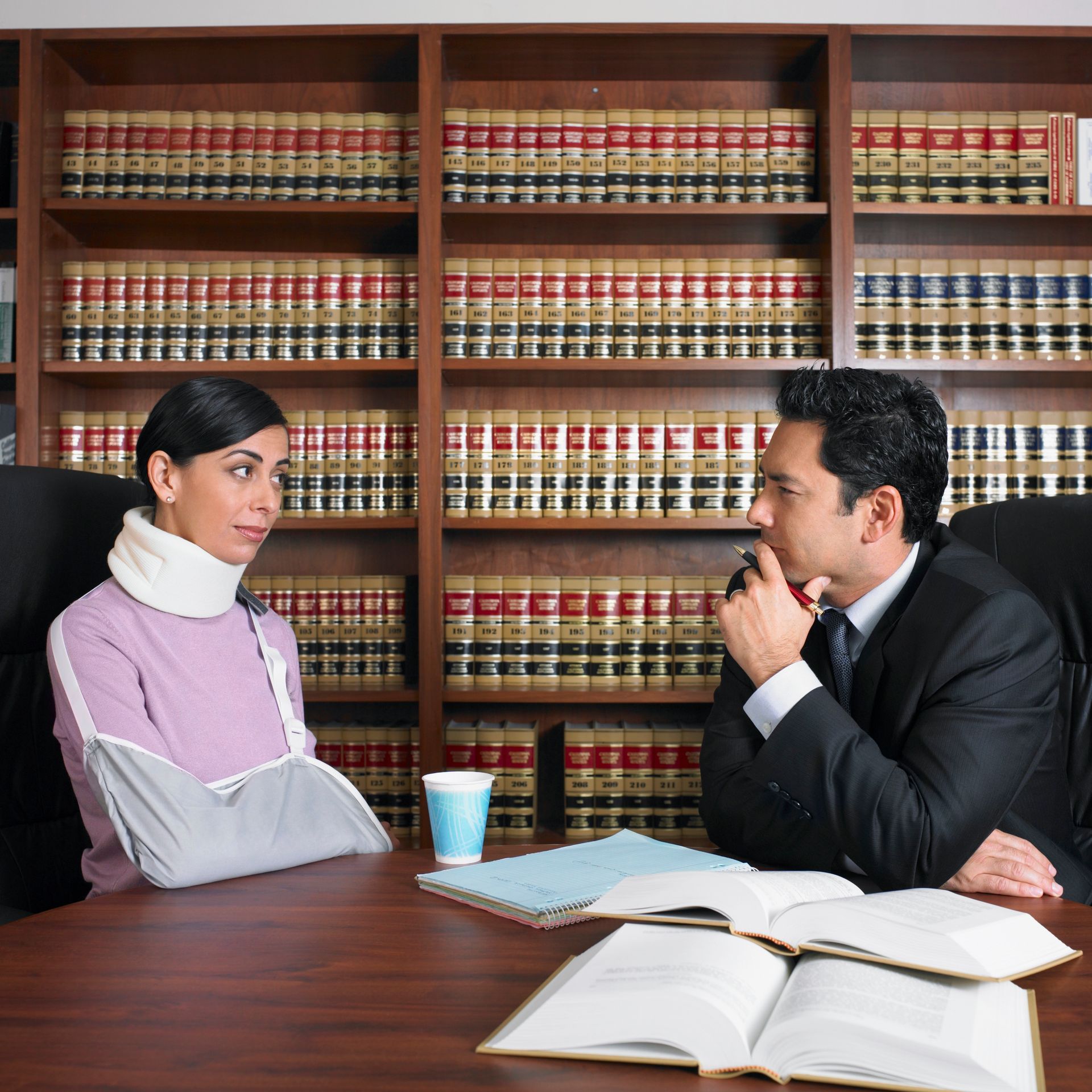A male lawyer is talking to an injured client who is looking for legal counseling.