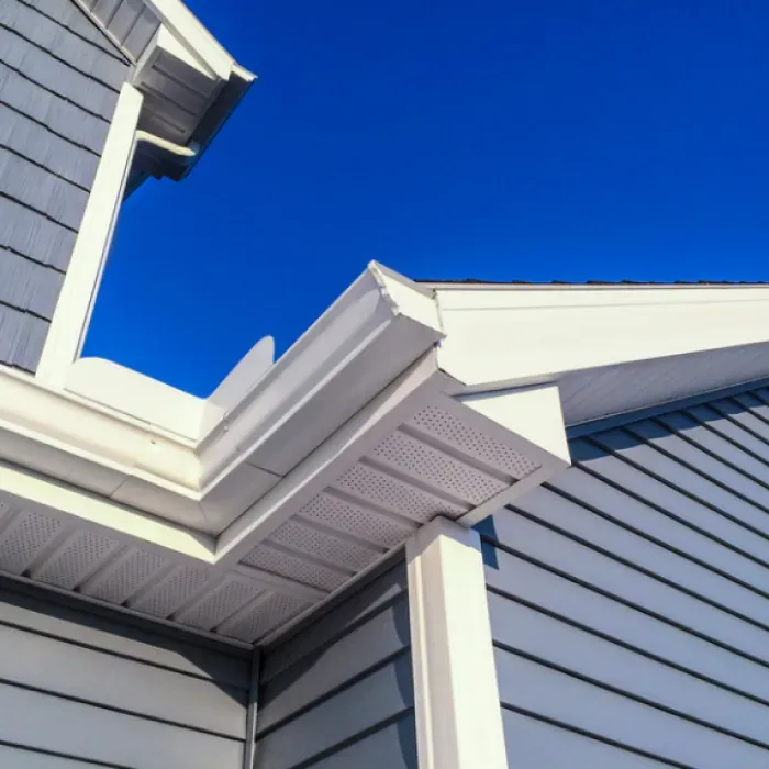 The roof of a house with a blue sky in the background