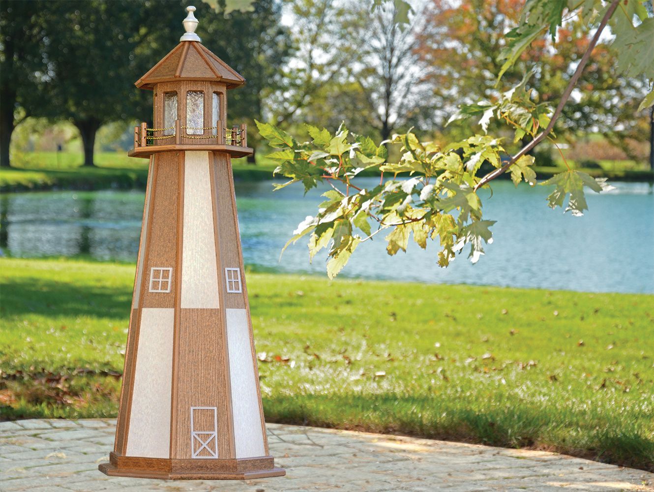 Decorative lighthouse on a patio with a pond and trees in the background. Brown and white vertical stripes.