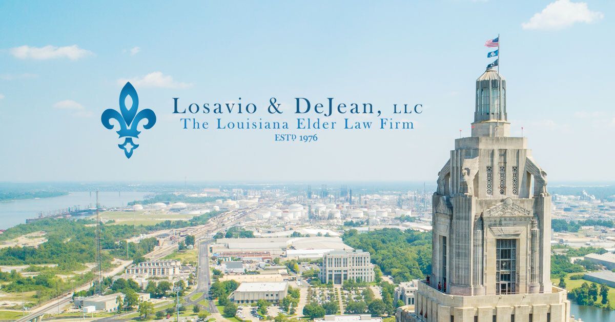 Losavio & DeJean law firm logo over city skyline with a tall building at right