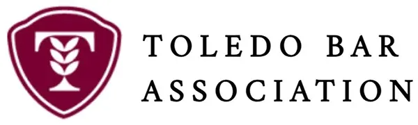 Toledo Bar Association logo with maroon shield and text