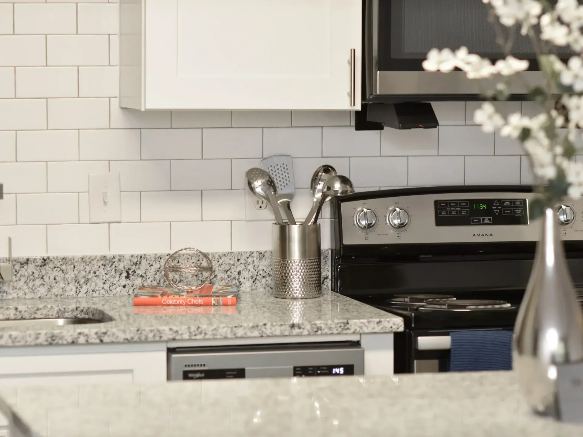 A kitchen with a stove, microwave, sink and dishwasher in West Knoxville, TN