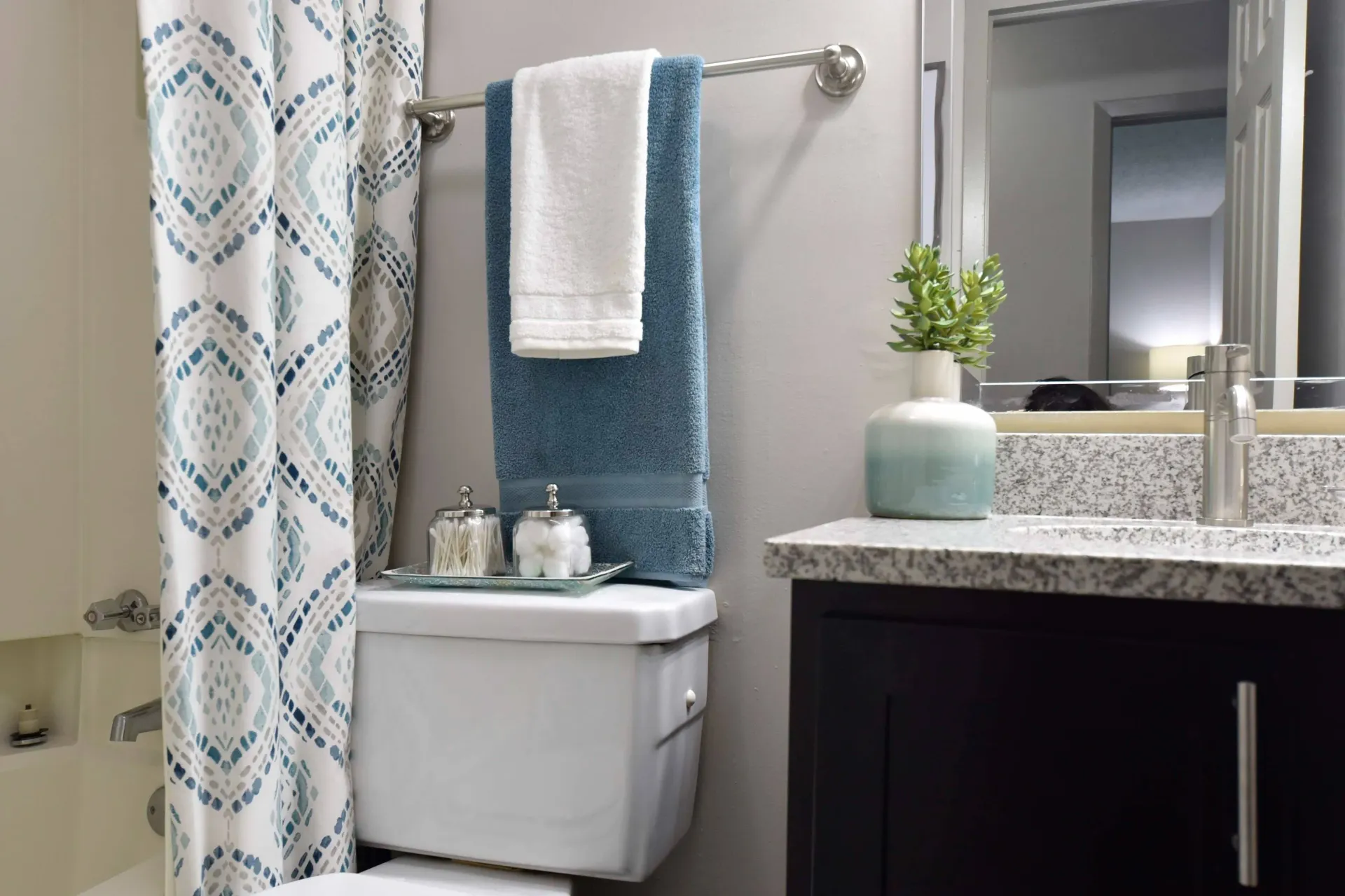 A fully furnished bathroom with a toilet , sink , and shower curtain West Knoxville, TN